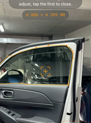 AR measuring app tracing a car window outline to exact dimensions