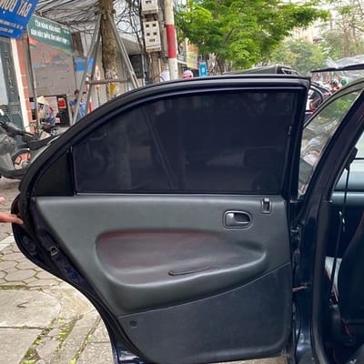 Custom-fit sun shades fitted to a MAZDA 323 1994-1998