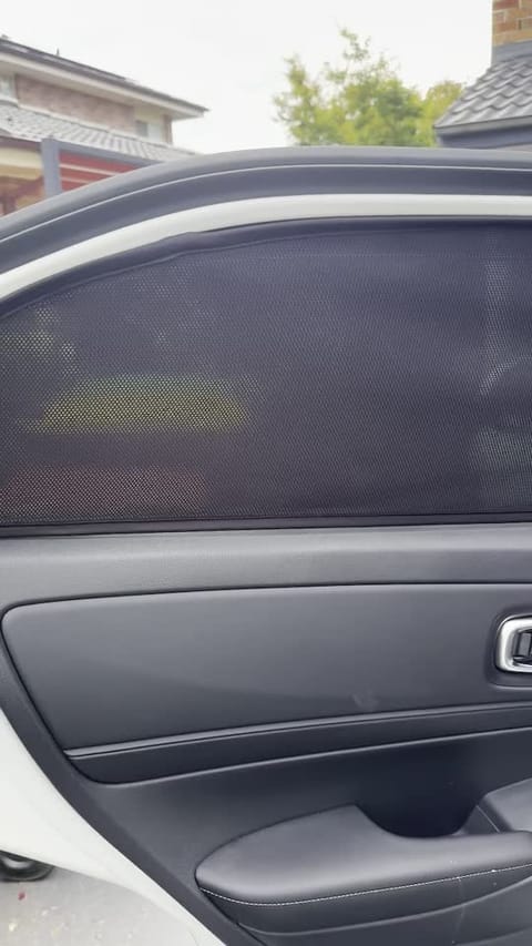 Custom-fit magnetic sun shade installed on a modern SUV window