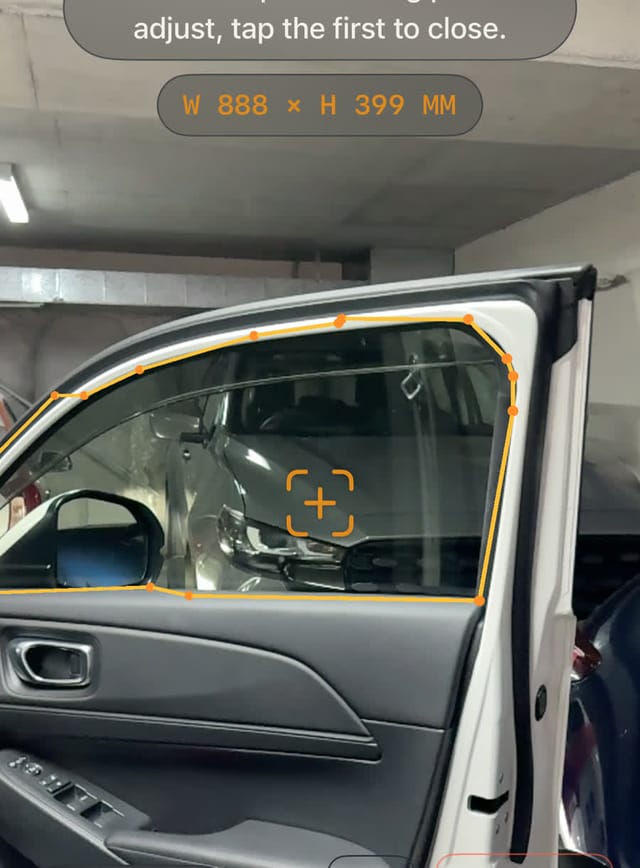 AR measuring app tracing a car window outline to exact dimensions