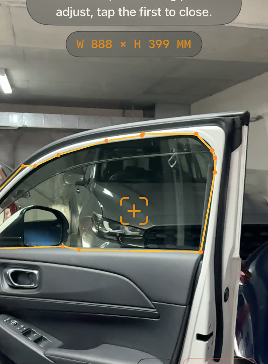AR measuring app tracing a car window outline to exact dimensions