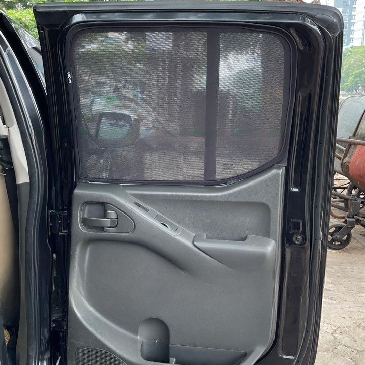 Nissan Navara D40 door window with the mesh shade fitted, wing mirror visible through it